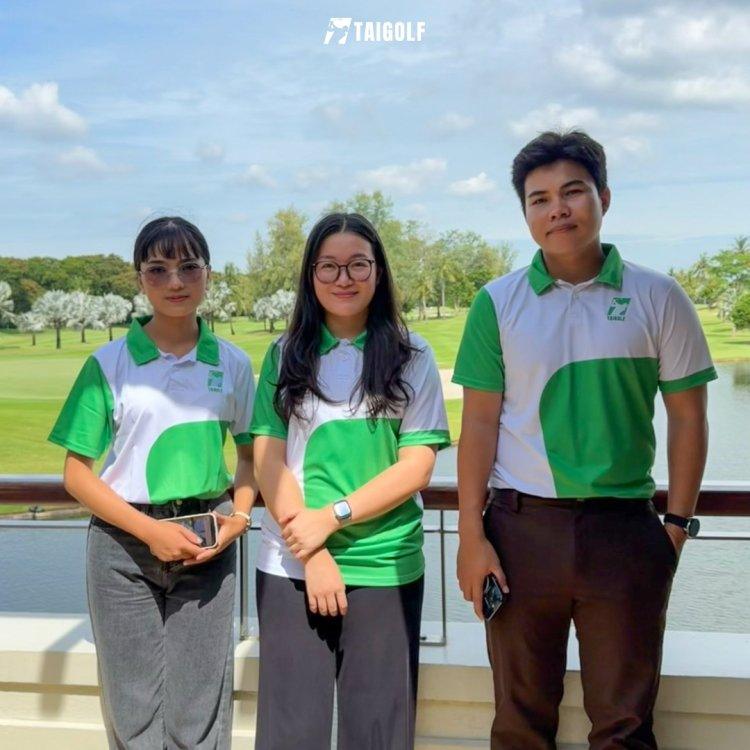 Three Taigolf team members in green team shirts at a golf club